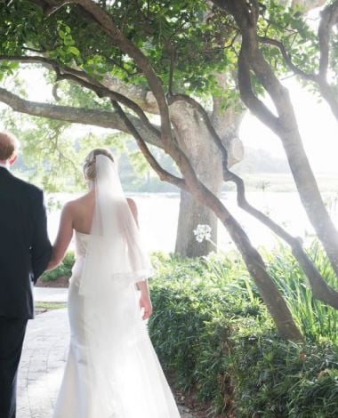 a bride and groom walking outside at Sea Island