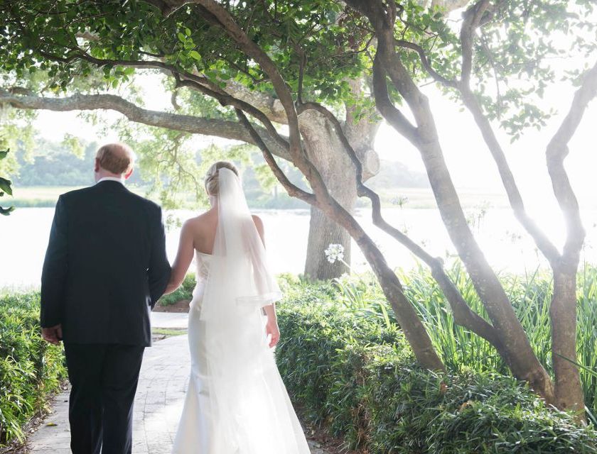 a bride and groom walking outside at Sea Island