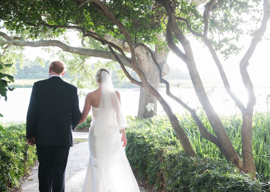 a bride and groom walking outside at Sea Island