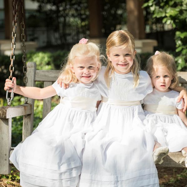 three young girls dressed for a wedding