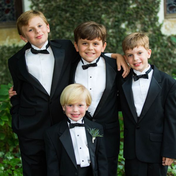 a group of young boys dressed for a wedding