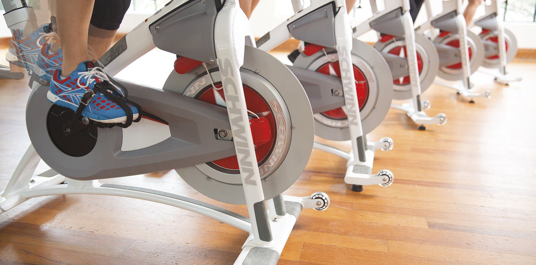 closeup of people cycling at the sea island fitness facilities