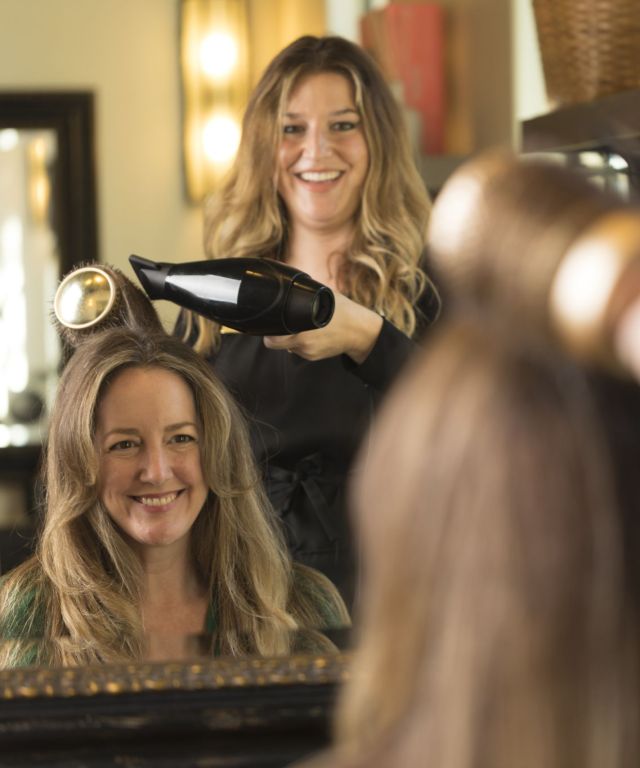 Woman receiving salon blowout hair treatment