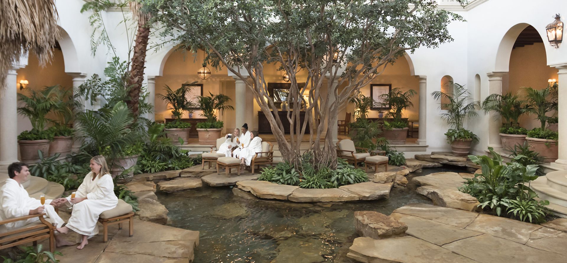 Guests seated at the Spa garden atrium in Sea Island Resort