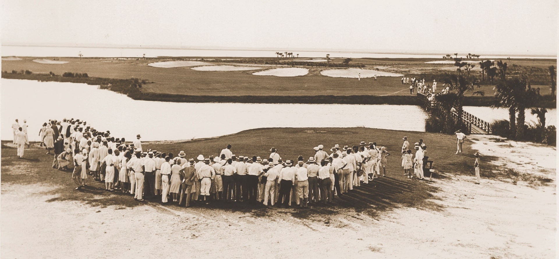 historic photo of people gathering around golf course