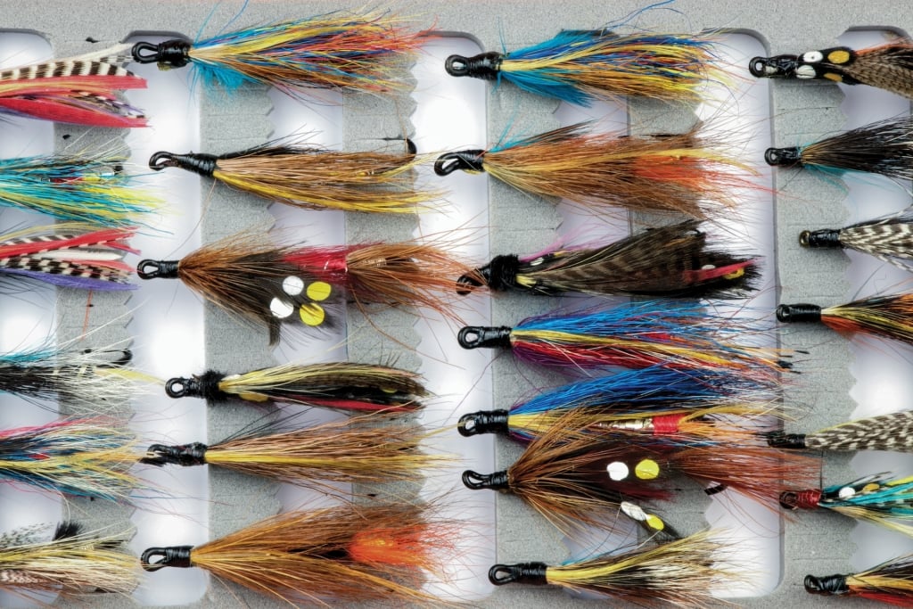 Traditional salmon fishing flies stored in a modern fly box