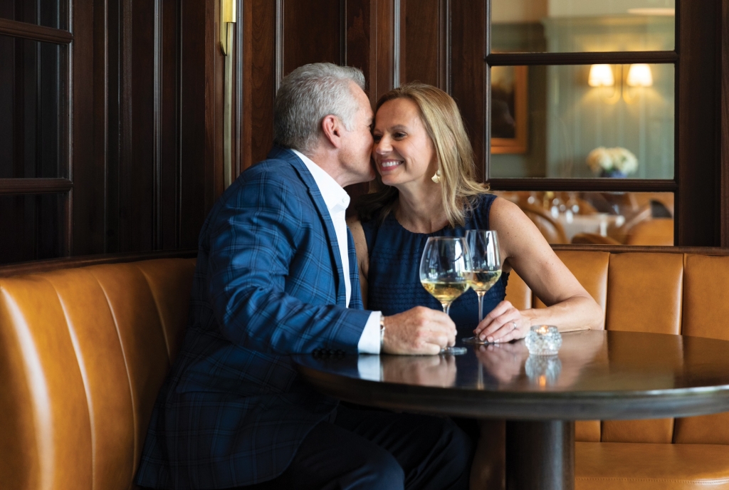 A couple enjoying wine at Colt & Alison