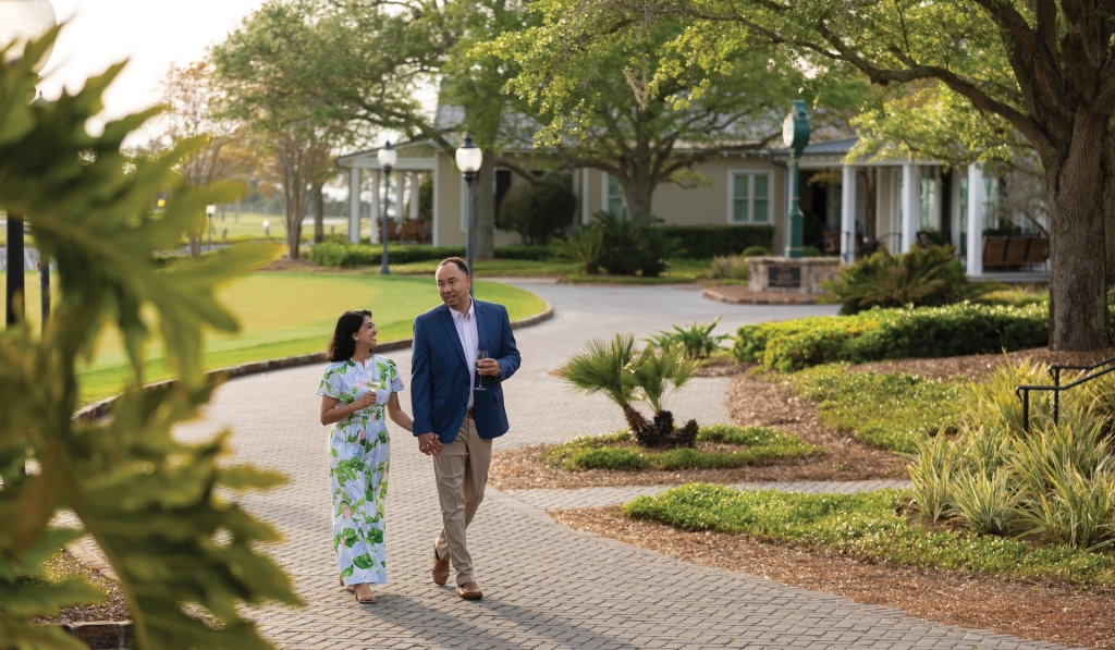 A couple enjoying an evening walk alongside nearby cottages