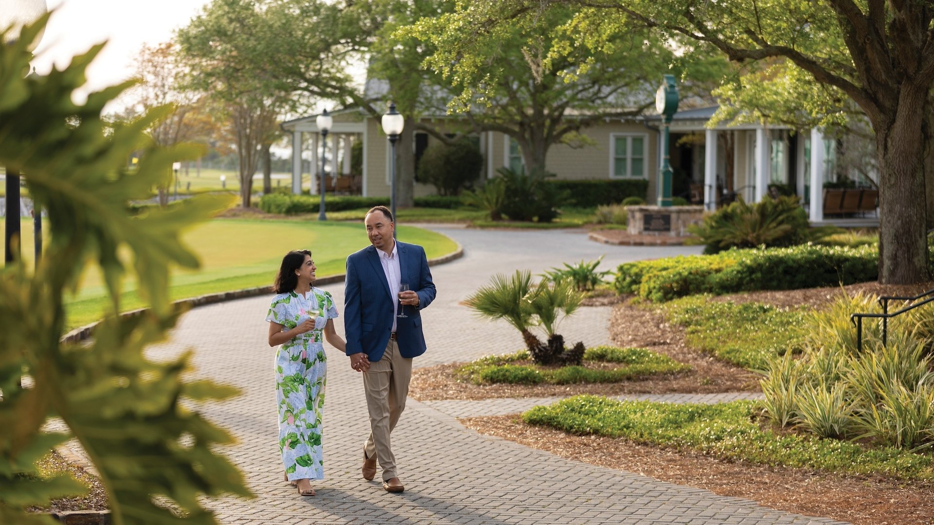 A couple enjoying an evening walk alongside nearby cottages