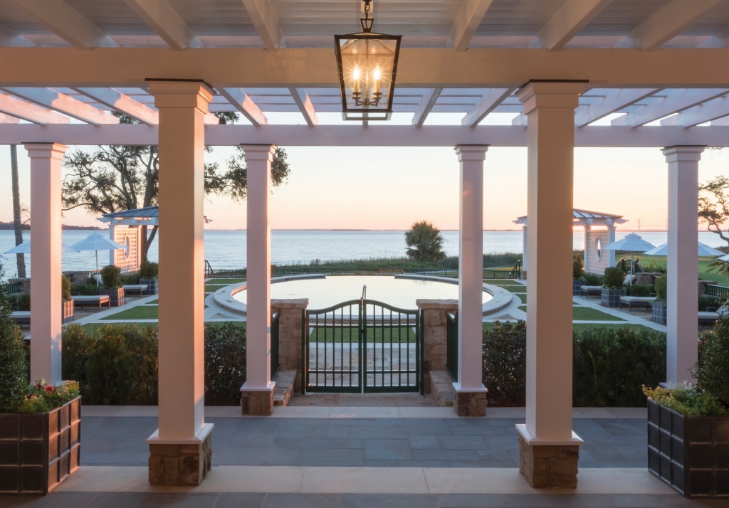 The view of a lakeside pool from an archway