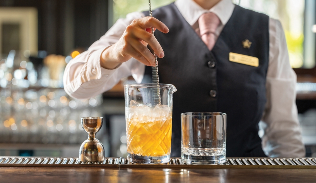 Stirring a Signature Barrel-Aged Manhattan at Oak Room.