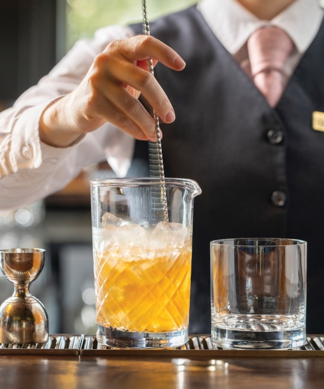 Stirring a Signature Barrel-Aged Manhattan at Oak Room.