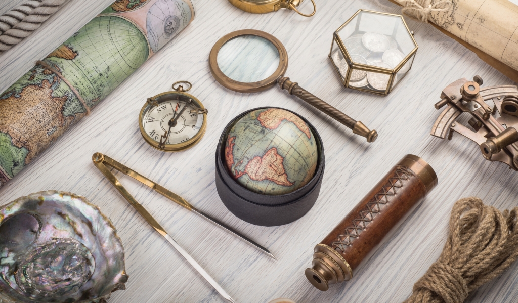 Travel accessories on desk. Exploration and nautical theme grunge background. Retro style.
