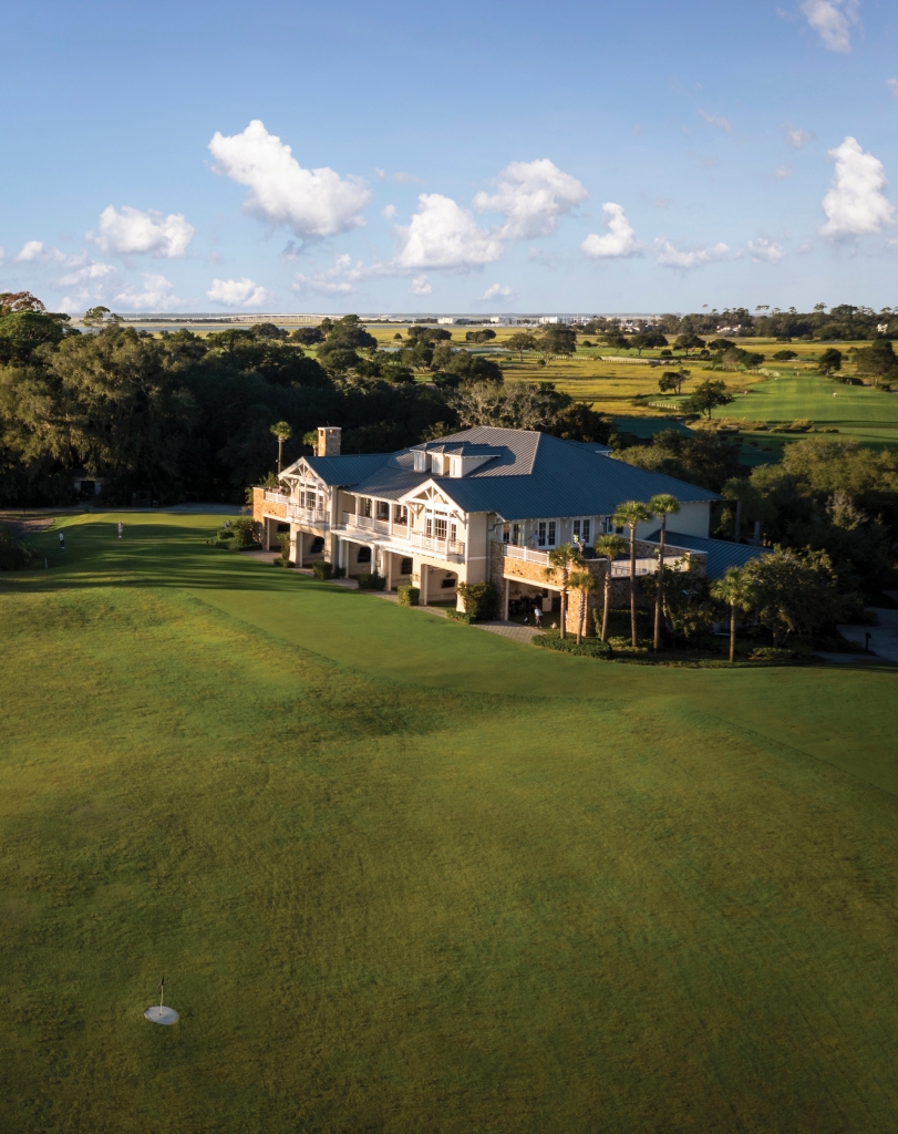 An aerial view of a golf clubhouse overlooking a green.