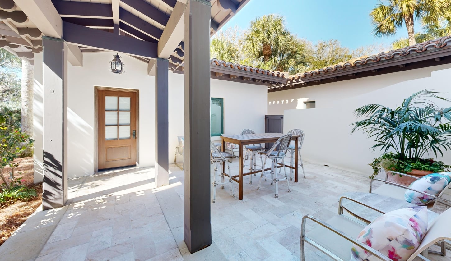 Entrance to Beach Club 402 featuring a patio with seating to the right