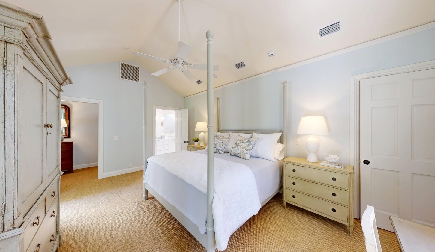 A king bed with a dresser next to it