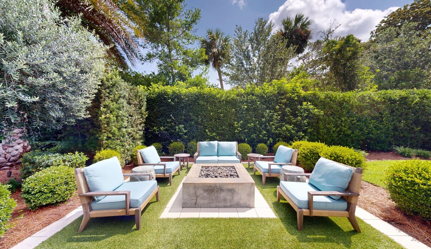 A private outdoor seating area around a fire table