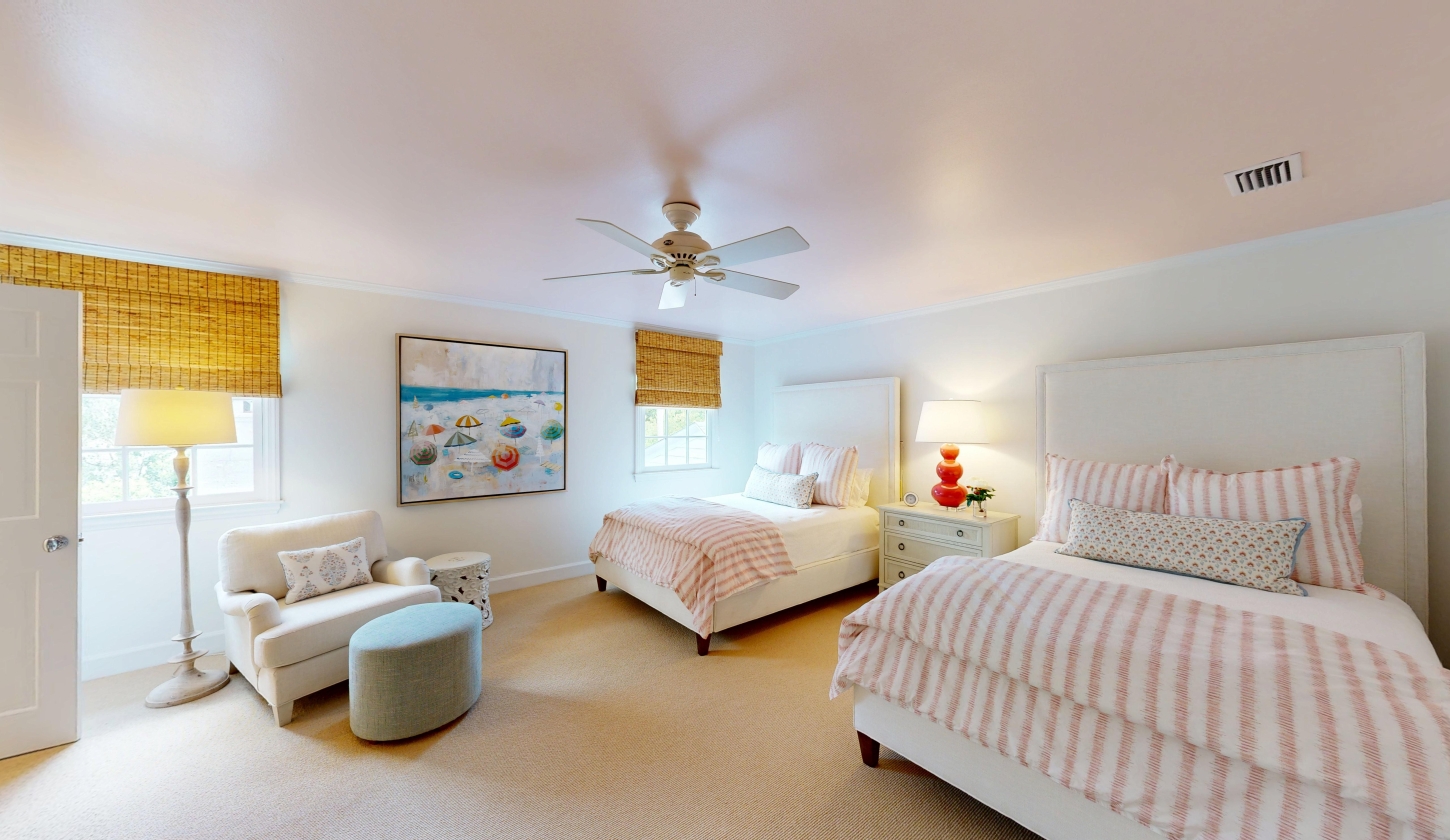 A large bedroom with two spacious beds and a sitting area